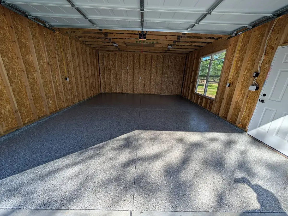Gray flake floor in a wood-paneled garage