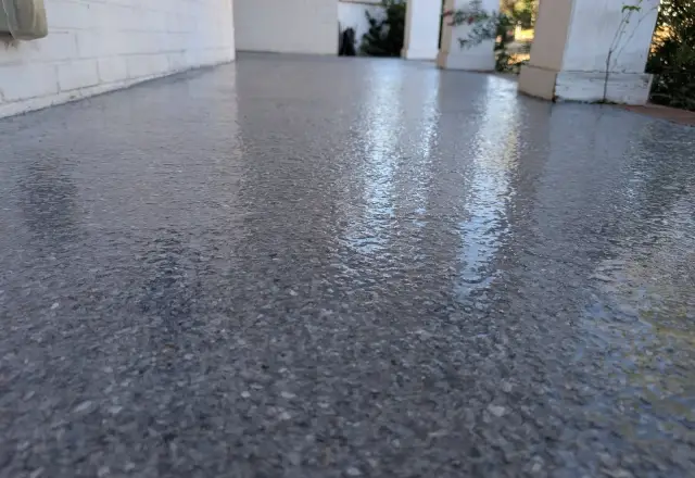 Sunlit glossy flake floor under a polyaspartic topcoat