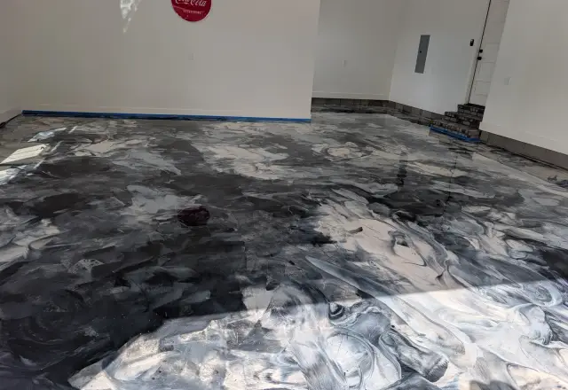 Black and silver metallic epoxy floor with marble-like swirls